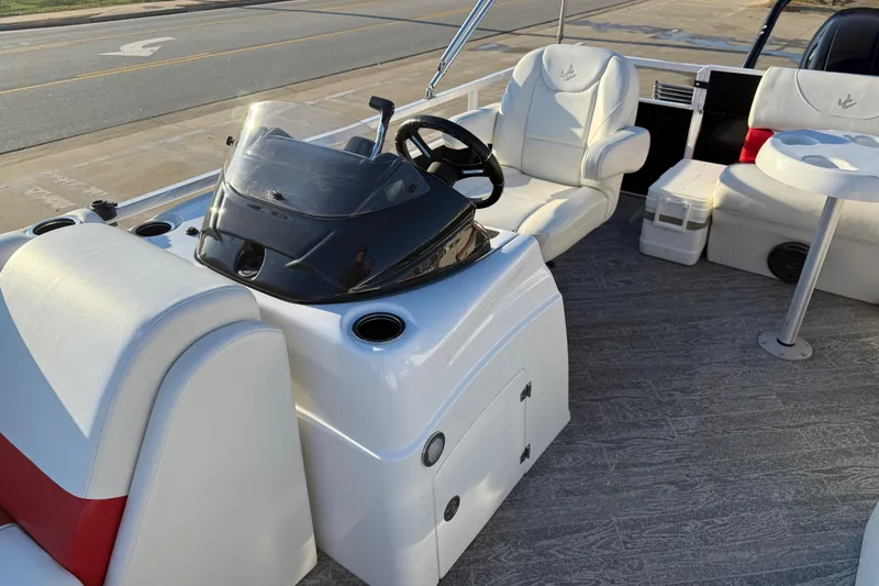 Slide: The Image of 2021 JC Spirit 221TT boat interior with steering console and seating. - 16