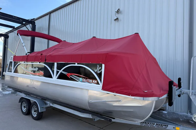 Slide: The Image of 2021 JC Spirit 221TT pontoon boat with red cover on trailer. - 33