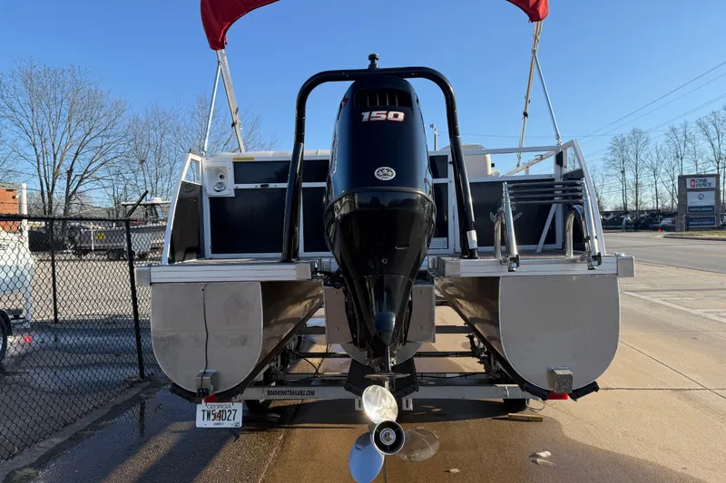 Slide: The Image of 2021 JC Spirit 221TT pontoon boat with 150 HP engine, parked on trailer. - 8