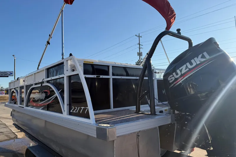 Slide: The Image of 2021 JC Spirit 221TT pontoon boat with Suzuki outboard motor, parked outdoors. - 9