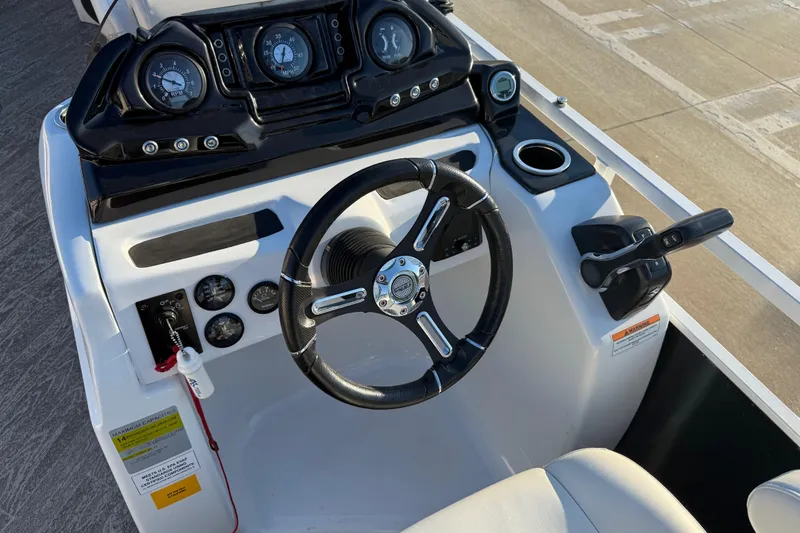 Slide: The Image of Steering console of 2021 JC Spirit 221TT boat with gauges and controls. - 19