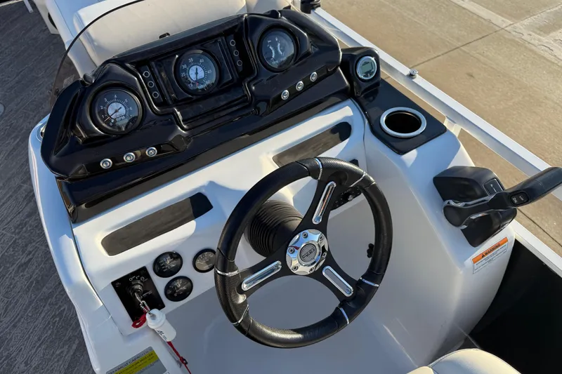 Slide: The Image of Steering console of 2021 JC Spirit 221TT boat with gauges and controls. - 26