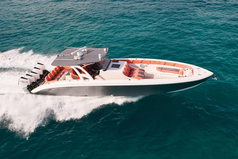 The Image of Midnight Express 43 Open boat cruising on clear blue water, showcasing sleek design and powerful engines. - 0