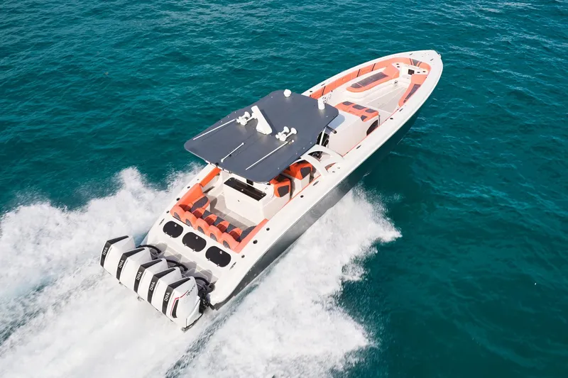 Slide: The Image of Midnight Express 43 Open boat cruising on clear blue water, showcasing powerful engines. - 1