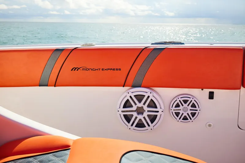 Slide: The Image of Midnight Express 43 Open boat interior with orange seating and audio speakers, ocean view. - 13