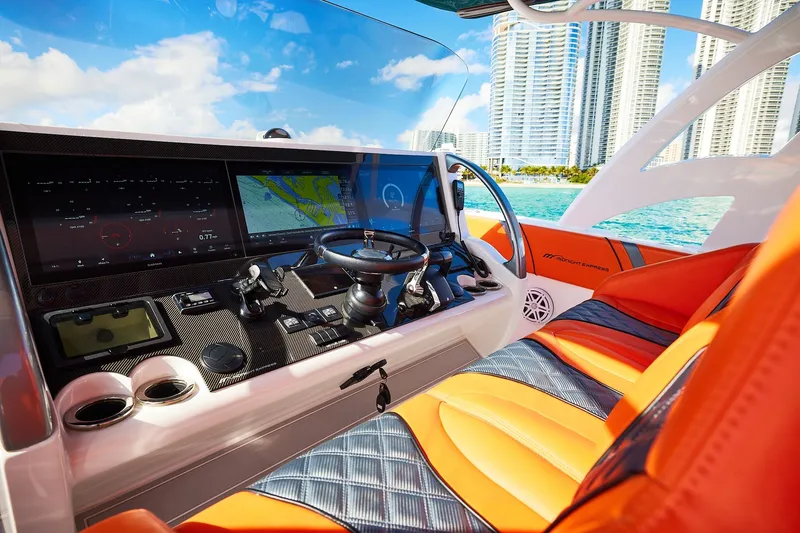 Slide: The Image of Luxurious Midnight Express 43 Open boat interior with advanced navigation system and vibrant orange seating. - 14