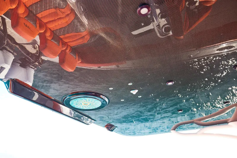 Slide: The Image of Underside view of Midnight Express 43 Open boat reflecting on water. - 17