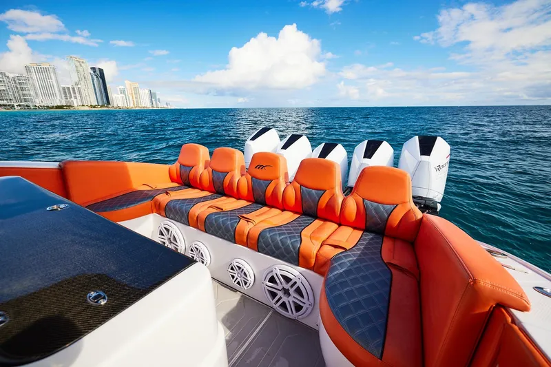 Slide: The Image of Luxury Midnight Express 43 Open boat with orange seating, ocean view, and city skyline. - 21