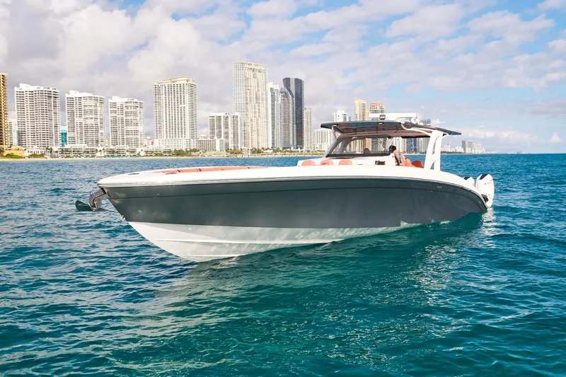 Slide: The Image of Luxury Midnight Express 43 Open boat cruising near city skyline on a sunny day. - 6