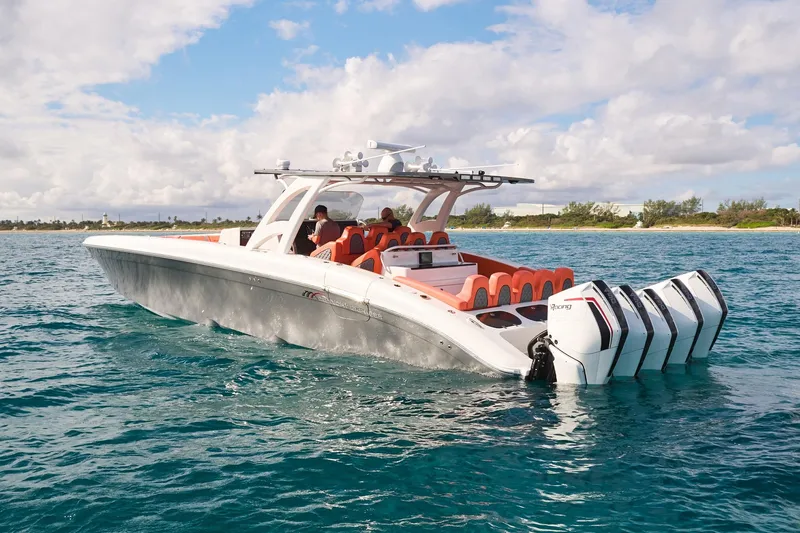 Slide: The Image of Luxury Midnight Express 43 Open boat with multiple engines cruising on clear blue water. - 7