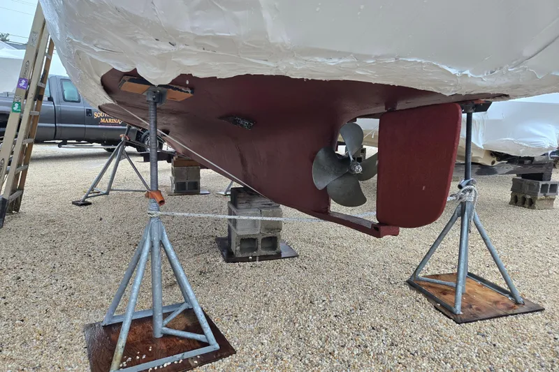 Slide: The Image of 1982 SISU 26 boat hull on stands, showing propeller and rudder. - 10