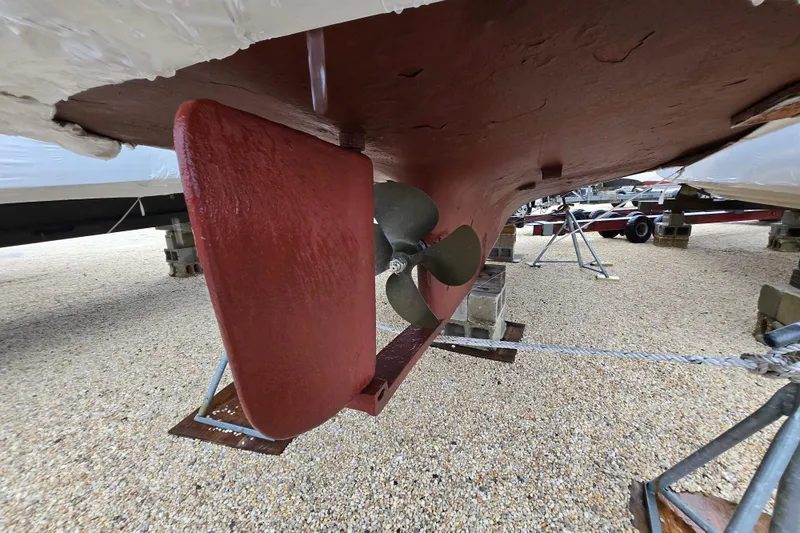 Slide: The Image of 1982 SISU 26 boat propeller and rudder on dry dock, showcasing marine engineering. - 11