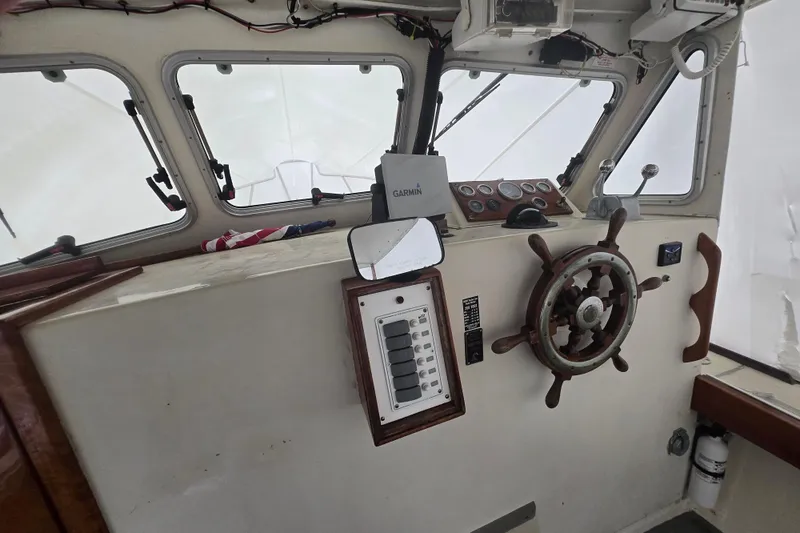 Slide: The Image of Interior of a 1982 SISU 26 boat cockpit with steering wheel and navigation equipment. - 15