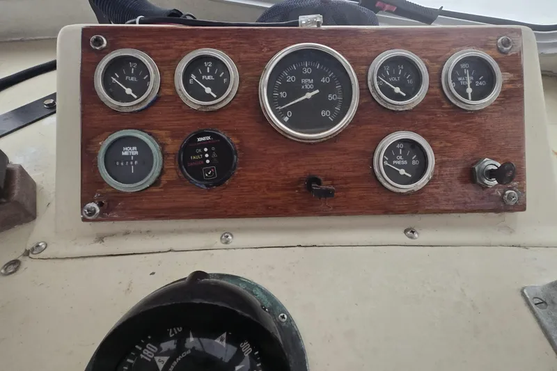 Slide: The Image of Control panel of a 1982 SISU 26 boat with gauges and switches. - 19