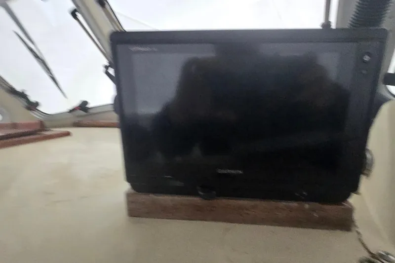 Slide: The Image of Boat dashboard with a mounted screen inside a 1982 SISU 26 vessel. - 21