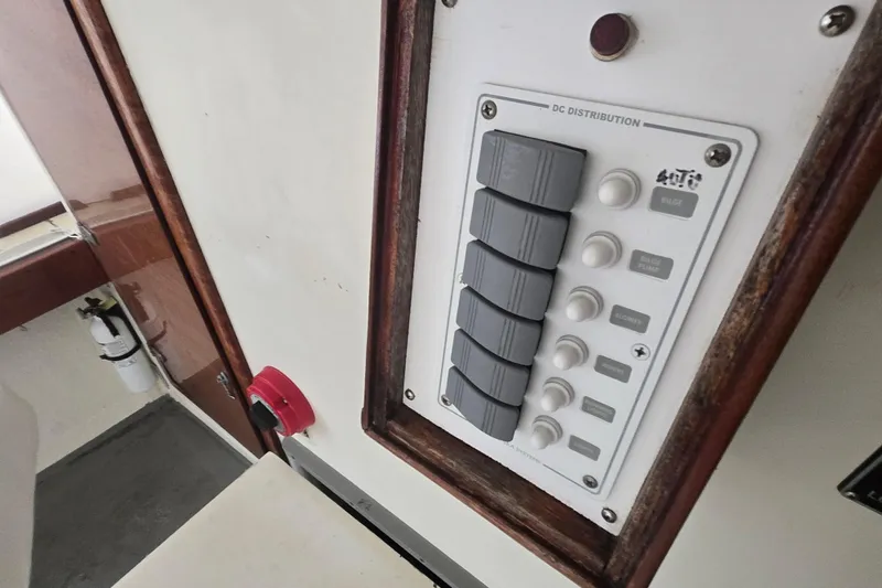 Slide: The Image of Control panel of a 1982 SISU 26 boat with switches and fire extinguisher. - 22