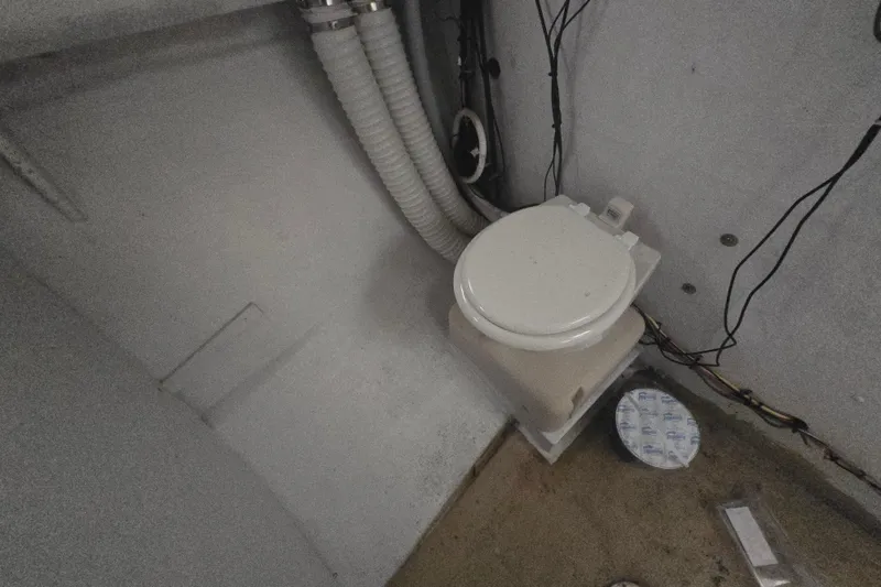 Slide: The Image of Compact marine toilet setup in a 1982 SISU 26 boat interior. - 29