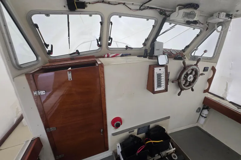 Slide: The Image of Interior of a 1982 SISU 26 boat with steering wheel and control panel. - 5