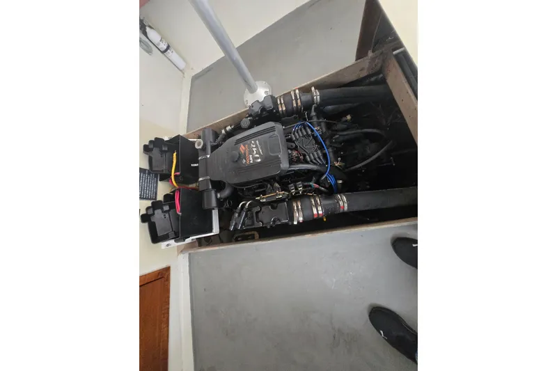 Slide: The Image of Engine compartment of a 1982 SISU 26 boat, showcasing mechanical components and wiring. - 8