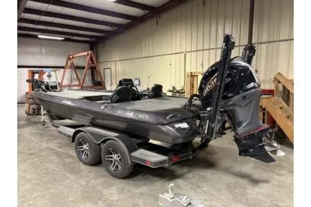 Slide: The Image of 2023 Skeeter ZXR20 boat in a warehouse, featuring dual motors and a sleek design. - 3