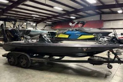 Slide: The Image of 2023 Skeeter ZXR20 boat in showroom, featuring sleek design and dual-axle trailer. - 4