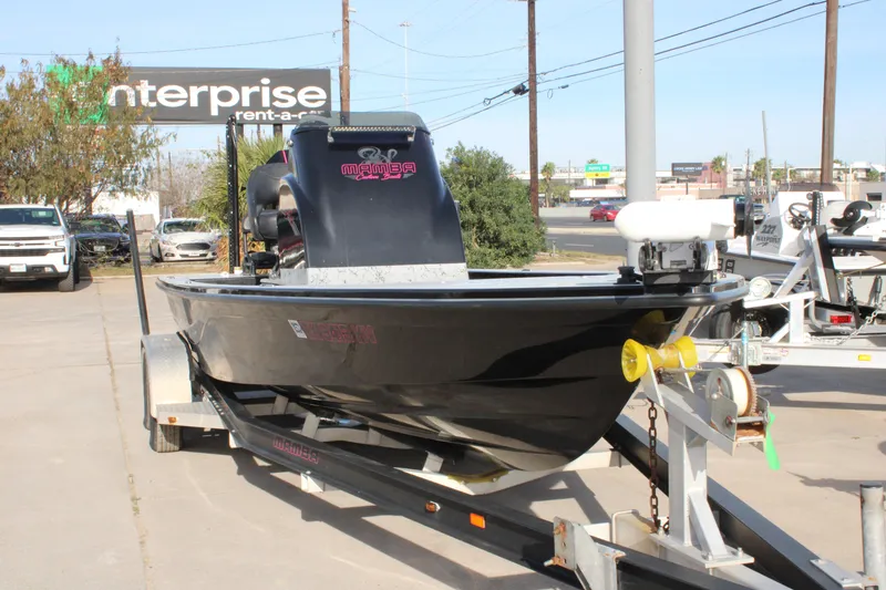 Slide: The Image of 2024 Mamba 24VX boat on trailer in parking lot, Enterprise sign in background. - 1