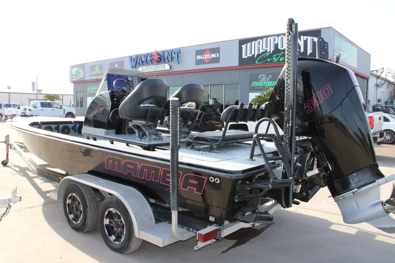 Slide: The Image of 2024 Mamba 24VX boat on trailer outside dealership, featuring powerful 300 engine. - 2