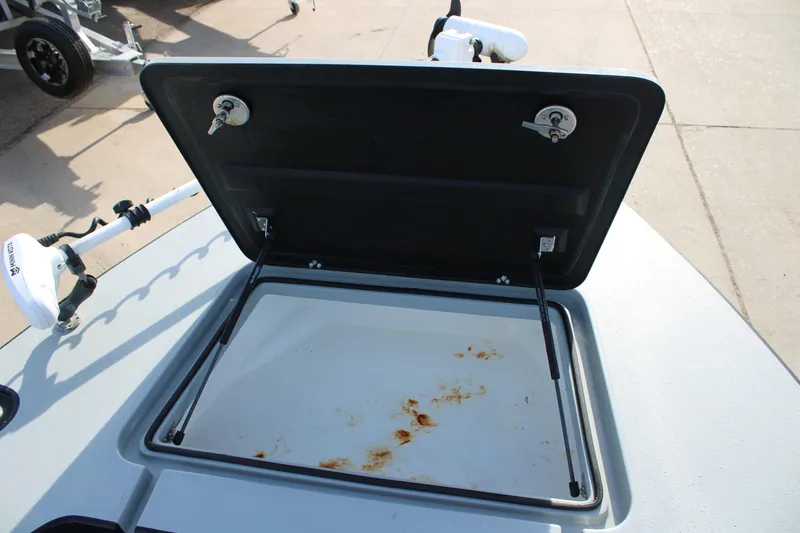 Slide: The Image of Open storage compartment on 2024 Mamba 24VX boat, showing interior details. - 22