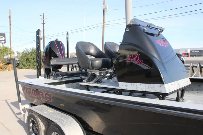 Slide: The Image of 2024 Mamba 24VX boat with sleek black design and comfortable seating on trailer. - 3