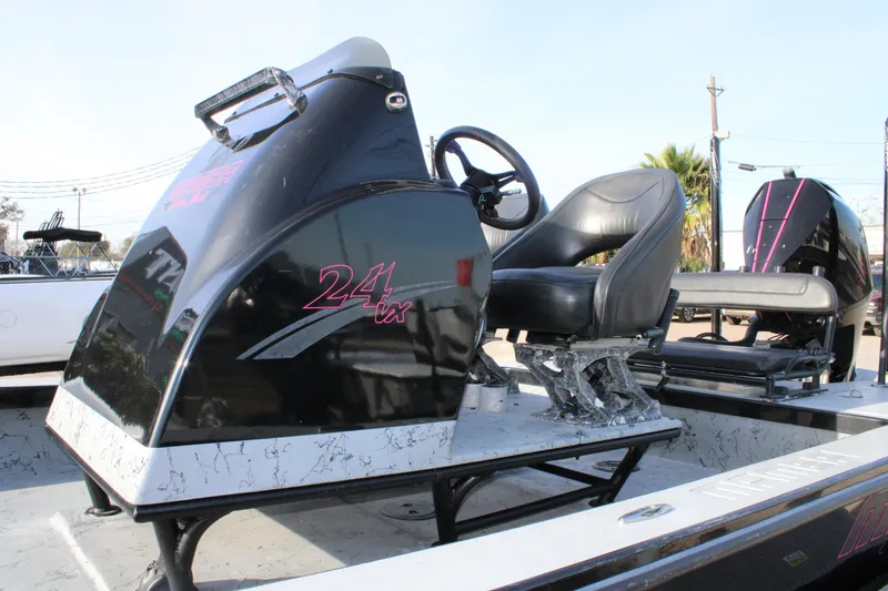 Slide: The Image of 2024 Mamba 24VX boat interior with black seating and steering console. - 5