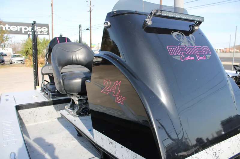 Slide: The Image of 2024 Mamba 24VX boat with custom seating and sleek black design. - 8