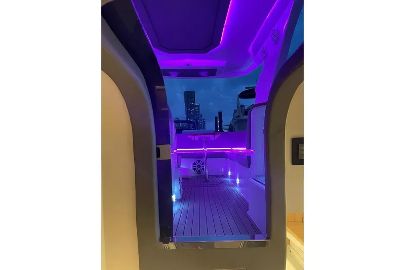 Slide: The Image of 2023 NX Boats NX340 interior with purple LED lighting and modern design. - 10