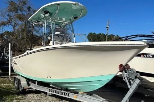The Image of 2020 Sea Chaser 22HFC boat on trailer, featuring a sleek design and mint green hull. - 1