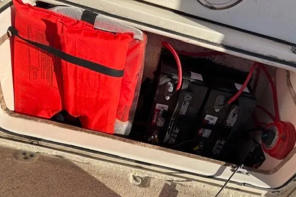 Slide: The Image of 2020 Sea Chaser 22HFC boat compartment with batteries and a red life jacket. - 11