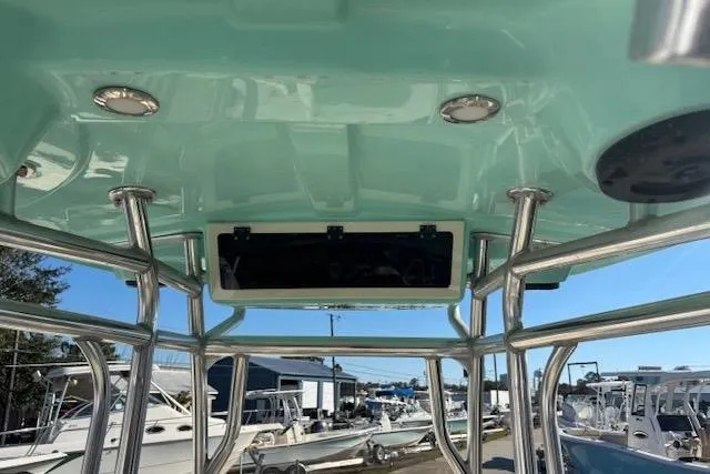 Slide: The Image of 2020 Sea Chaser 22HFC boat interior with teal ceiling and stainless steel framework. - 7