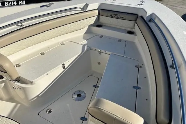 Slide: The Image of 2020 Sea Chaser 22HFC boat interior with beige seating and storage compartments. - 8