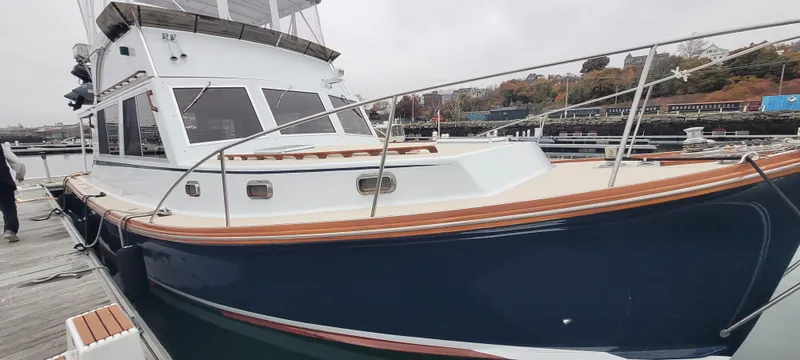 Slide: The Image of 1989 Duffy Wilbur 42 Flybridge Cruiser docked, showcasing sleek design and spacious deck. - 1