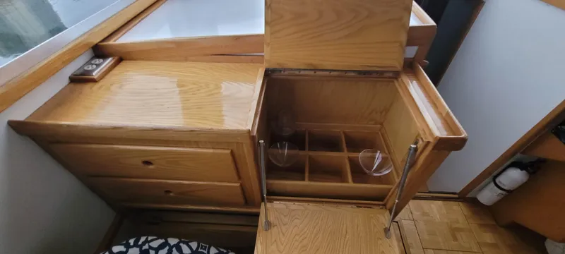 Slide: The Image of Wooden cabinet with open storage compartments on a 1989 Duffy Wilbur 42 Flybridge Cruiser. - 20