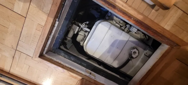 Slide: The Image of Engine compartment of 1989 Duffy Wilbur 42 Flybridge Cruiser, showcasing mechanical components. - 27