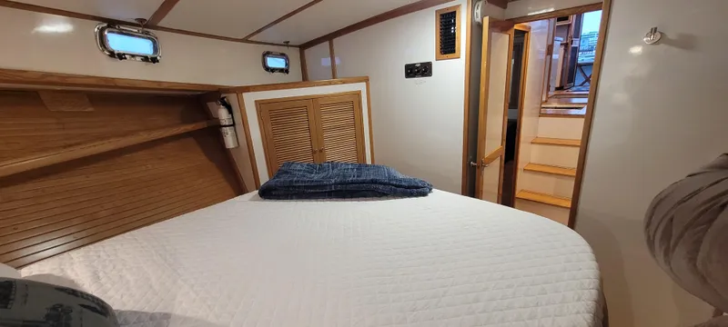 Slide: The Image of 1989 Duffy Wilbur 42 Flybridge Cruiser cabin with cozy bed and wooden interior. - 35
