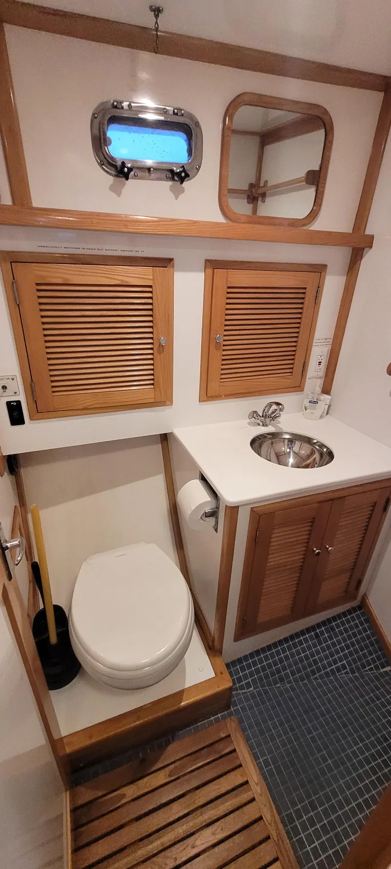 Slide: The Image of 1989 Duffy Wilbur 42 Flybridge Cruiser bathroom with wooden accents and compact design. - 38