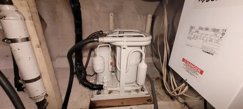 Slide: The Image of Engine room of 1989 Duffy Wilbur 42 Flybridge Cruiser with mechanical components. - 42