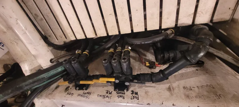 Slide: The Image of Engine compartment of 1989 Duffy Wilbur 42 Flybridge Cruiser with visible hoses and fittings. - 44