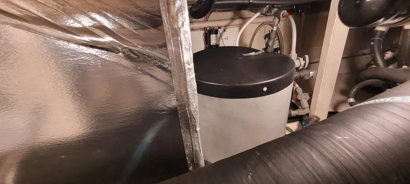 Slide: The Image of Engine room of 1989 Duffy Wilbur 42 Flybridge Cruiser with visible equipment and piping. - 49