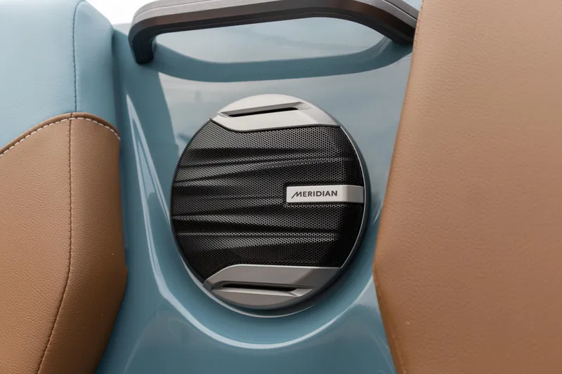 Slide: The Image of Meridian speaker on 2026 MasterCraft NXT23 boat, featuring blue and brown upholstery. - 13