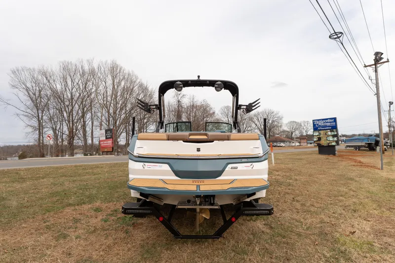 Slide: The Image of 2026 MasterCraft NXT23 boat displayed on grass near a road. - 3