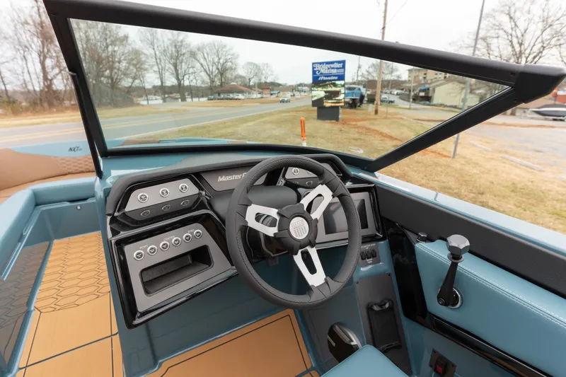 Slide: The Image of 2026 MasterCraft NXT23 boat interior with modern dashboard and steering wheel. - 8