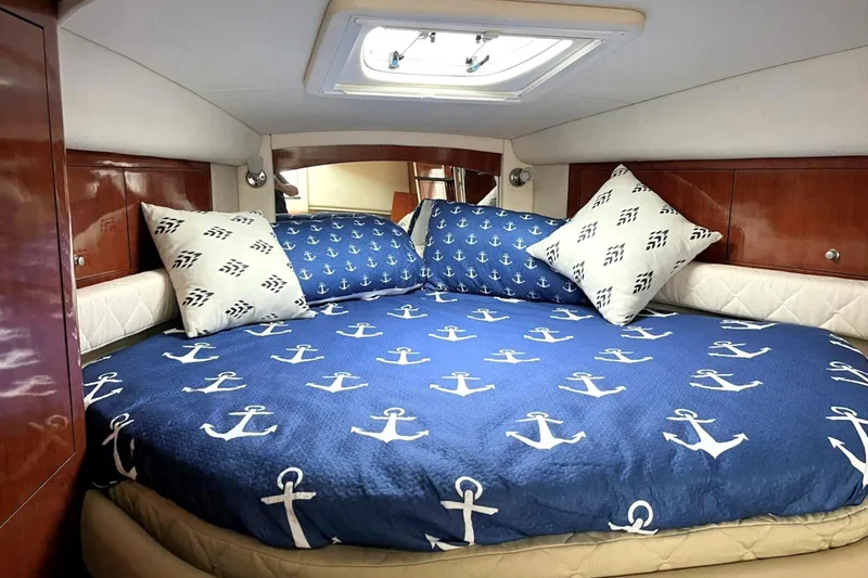 Slide: The Image of Luxurious cabin interior of 2006 Sea Ray 340 Sundancer with nautical-themed bedding. - 11