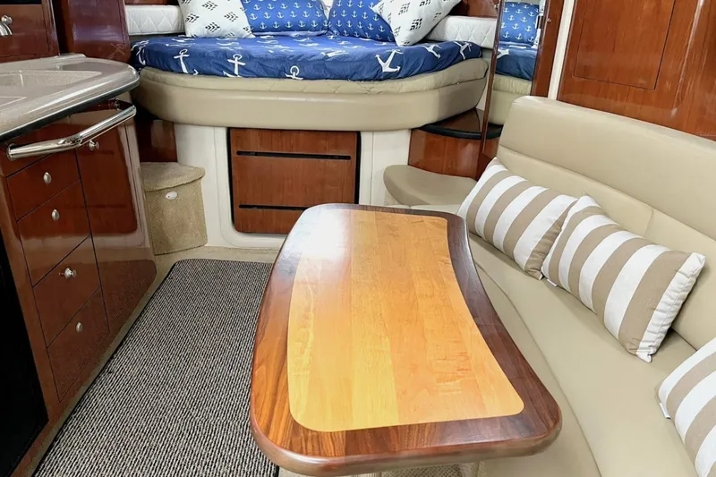 Slide: The Image of Interior of 2006 Sea Ray 340 Sundancer with cozy seating and nautical decor. - 7