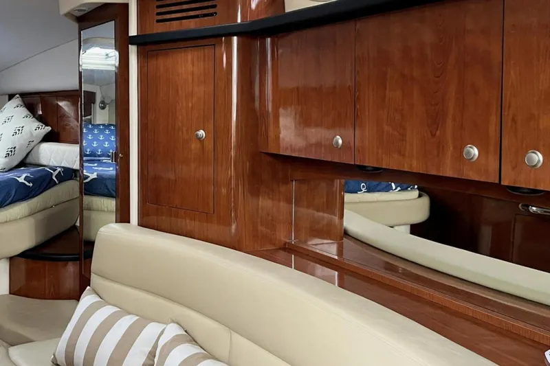 Slide: The Image of Luxurious interior of 2006 Sea Ray 340 Sundancer with wood cabinetry and cozy seating. - 8